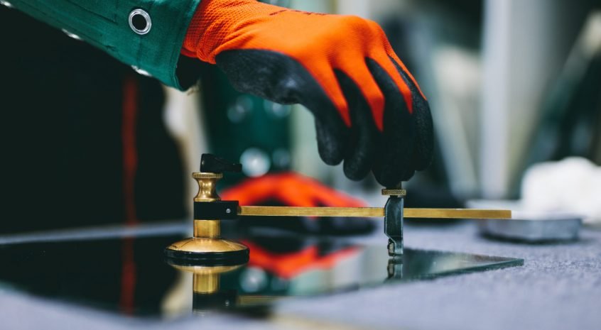 Glazier,Worker,Cutting,Glass,With,Compass,Glass,Cutter,In,A